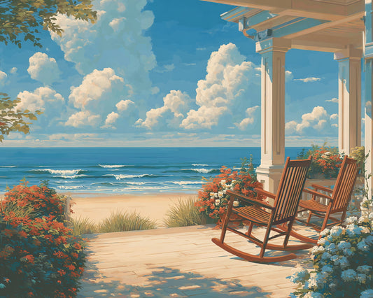 Rocking chairs on a porch overlooking the ocean with a clear blue sky.