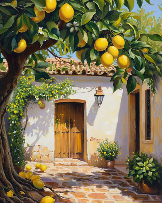 Lemon tree with ripe lemons in front of a white building with a wooden door.